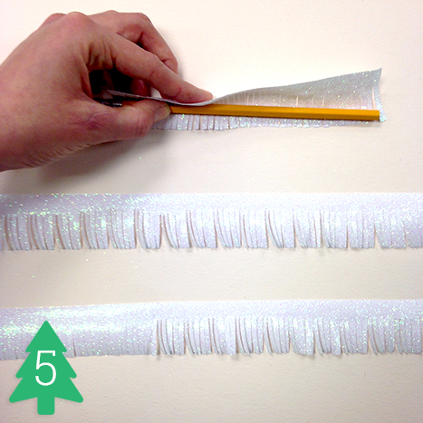 Cut slits into the gliter paper strips