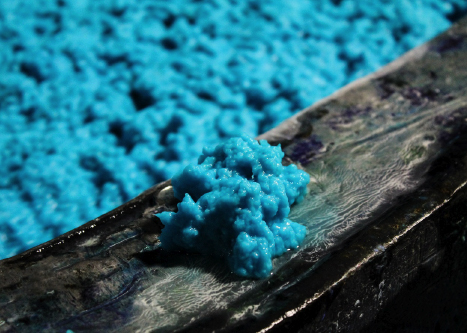 a close up of lagoon colored paper pulp