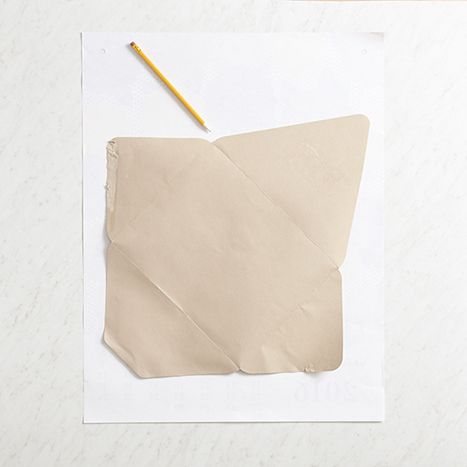 tracing a disassembled presentation envelope on paper