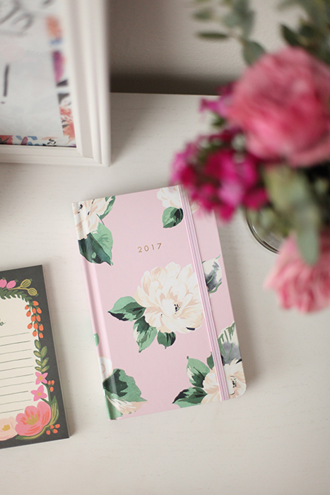 bouquet of flowers and a floral planner on a desk