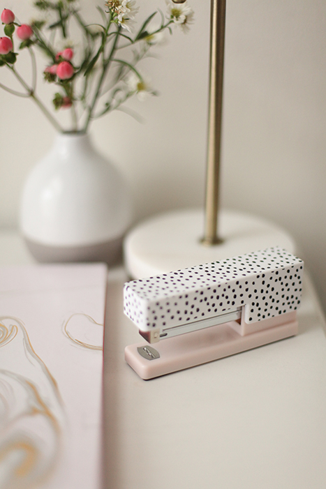 pink and polka dot stapler on a desk